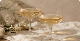 Two champagne coupes raised in celebration