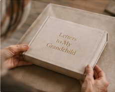 Hands holding a Letters to My Grandchild box